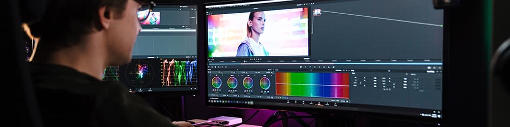 Back view of a man editing a video montage